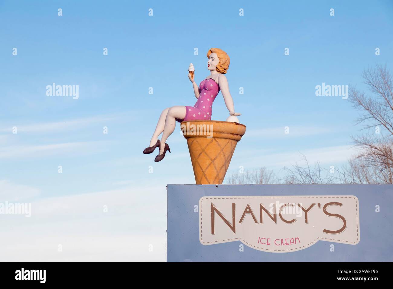 Belgrade, Serbia - February 2, 2020: Giant sculpture of an attractive woman sitting on a cone and eating ice cream on a top of ice cream shop on Ada C Stock Photo