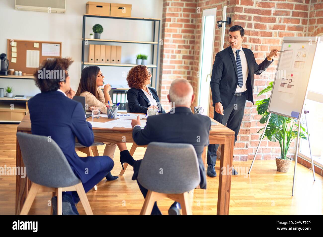 Group of business workers smiling happy and confident in a meeting