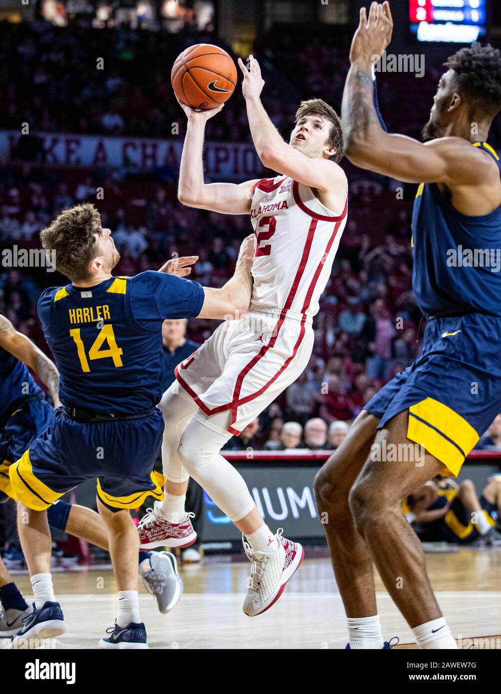 Norman, Oklahoma, USA. 8th Feb, 2020. Oklahoma Sooners guard Austin Reaves (12) shooting the basketball as West Virginia Mountaineers guard Chase Harler (14) draws the charging foul during the game on Saturday, February 8, 2020 at the Lloyd Noble Center in Norman, OK. Credit: Nicholas Rutledge/ZUMA Wire/Alamy Live News Stock Photo