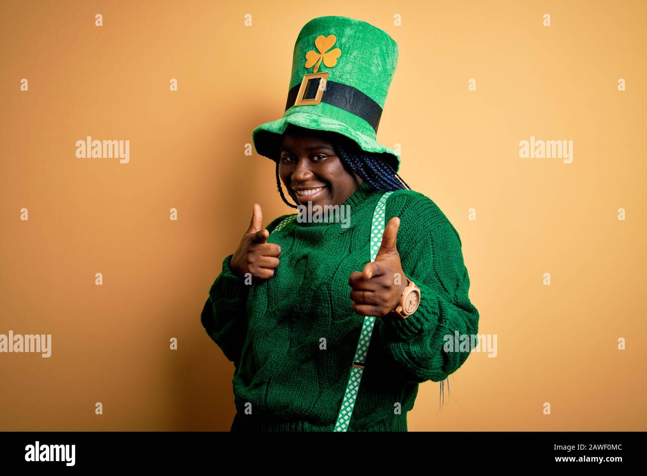 braids wearing green hat with clover 