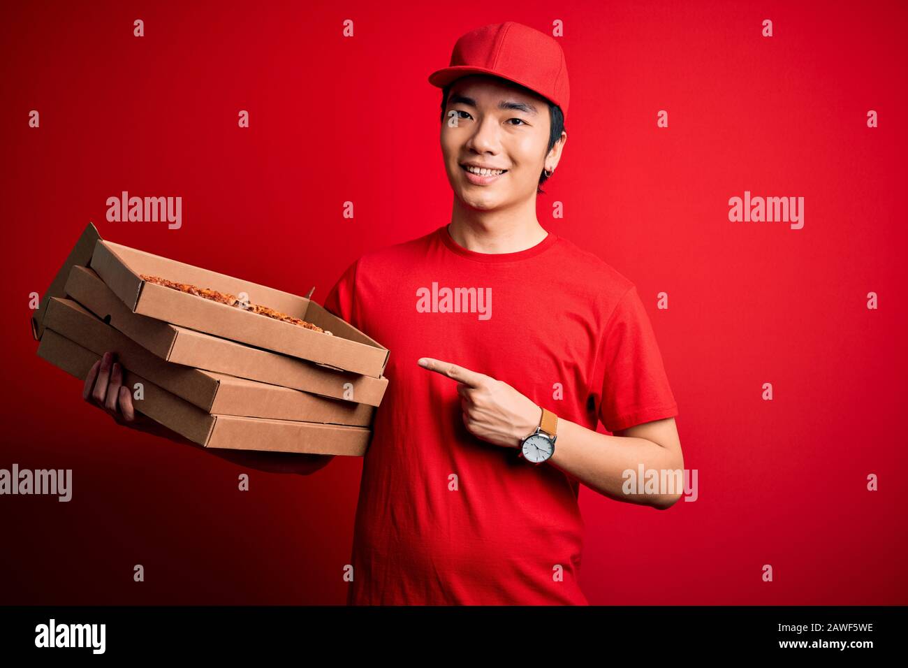 Young handsome chinese delivery man holding deliver boxes with Italian