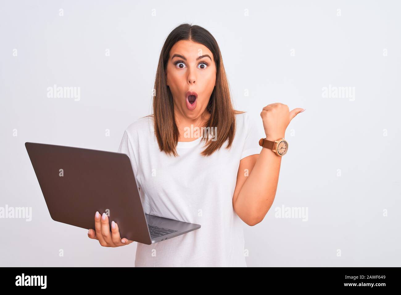 Beautiful young woman working using computer laptop over white ...