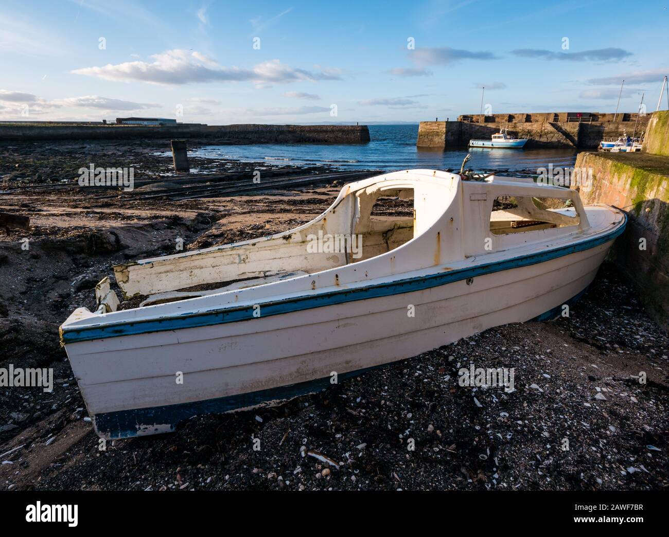 Abandoned boat aground, Cockenzie Harbour, East Lothian, Scotland, UK Stock Photo