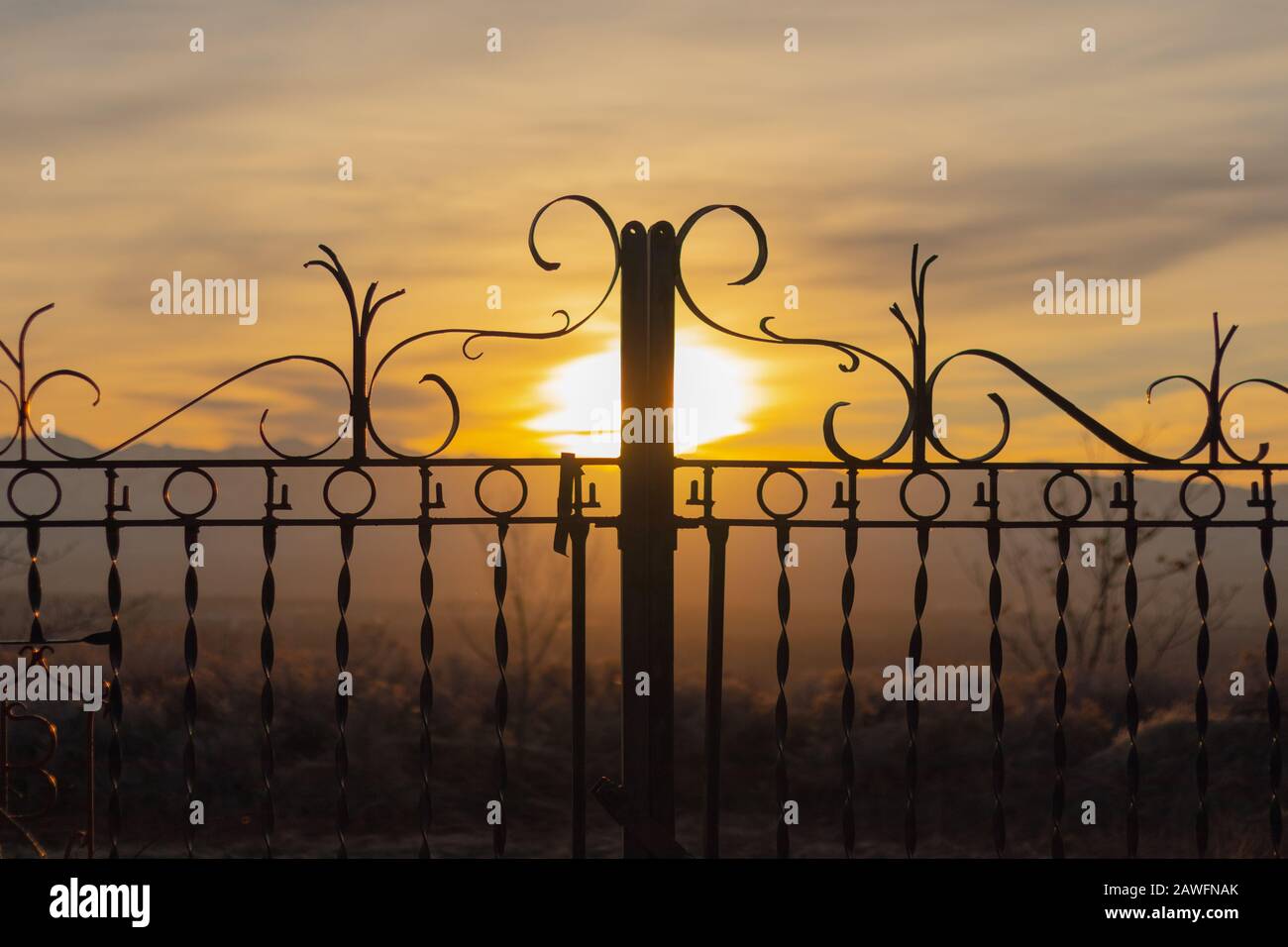 utah sunset through a wrought iron gate Stock Photo Alamy
