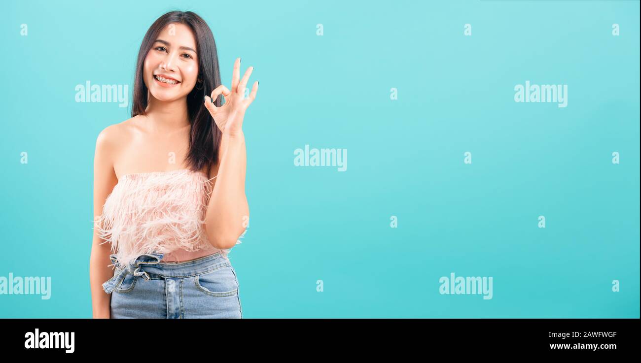 Smiling face asian beautiful woman her showing OK hand sign and looking ...