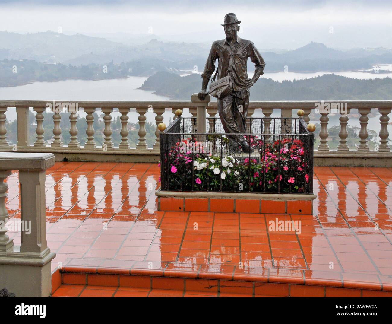 Bronze statue of Luis Villegas Lopez on viewing balcony at La Piedra Peñol (Peñol Rock) overlooking Embalse Peñol-Guatape (Peñol-Guatape Reservoir) on Stock Photo