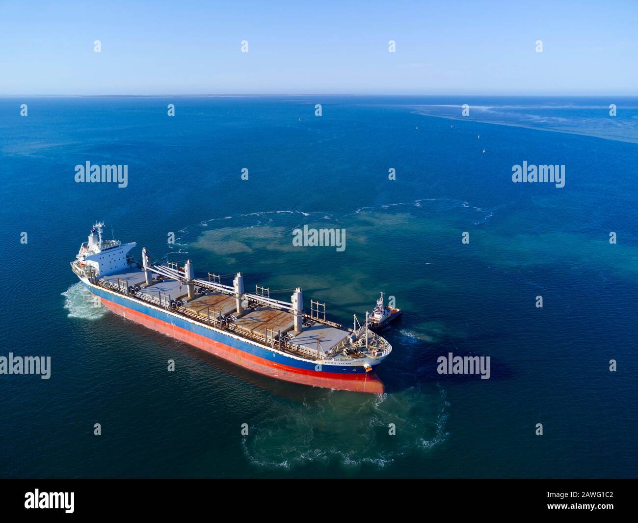 Bulk Carrier Ship berthing with tug assistance at Port Thevenard South Australia to load wheat for export Stock Photo