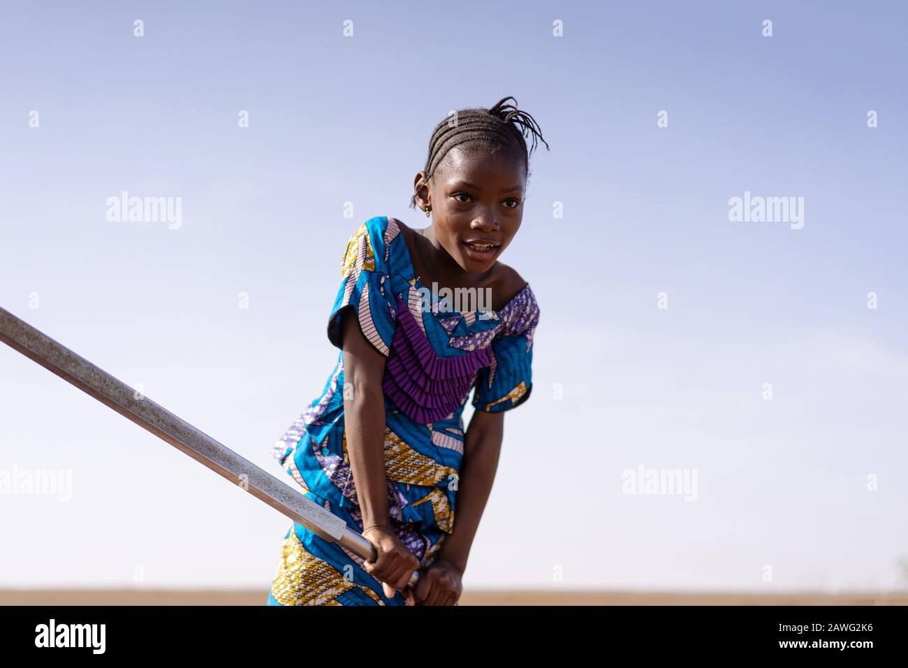 Real Aboriginal Youngster Collecting Fresh Water in a rural village Stock Photo