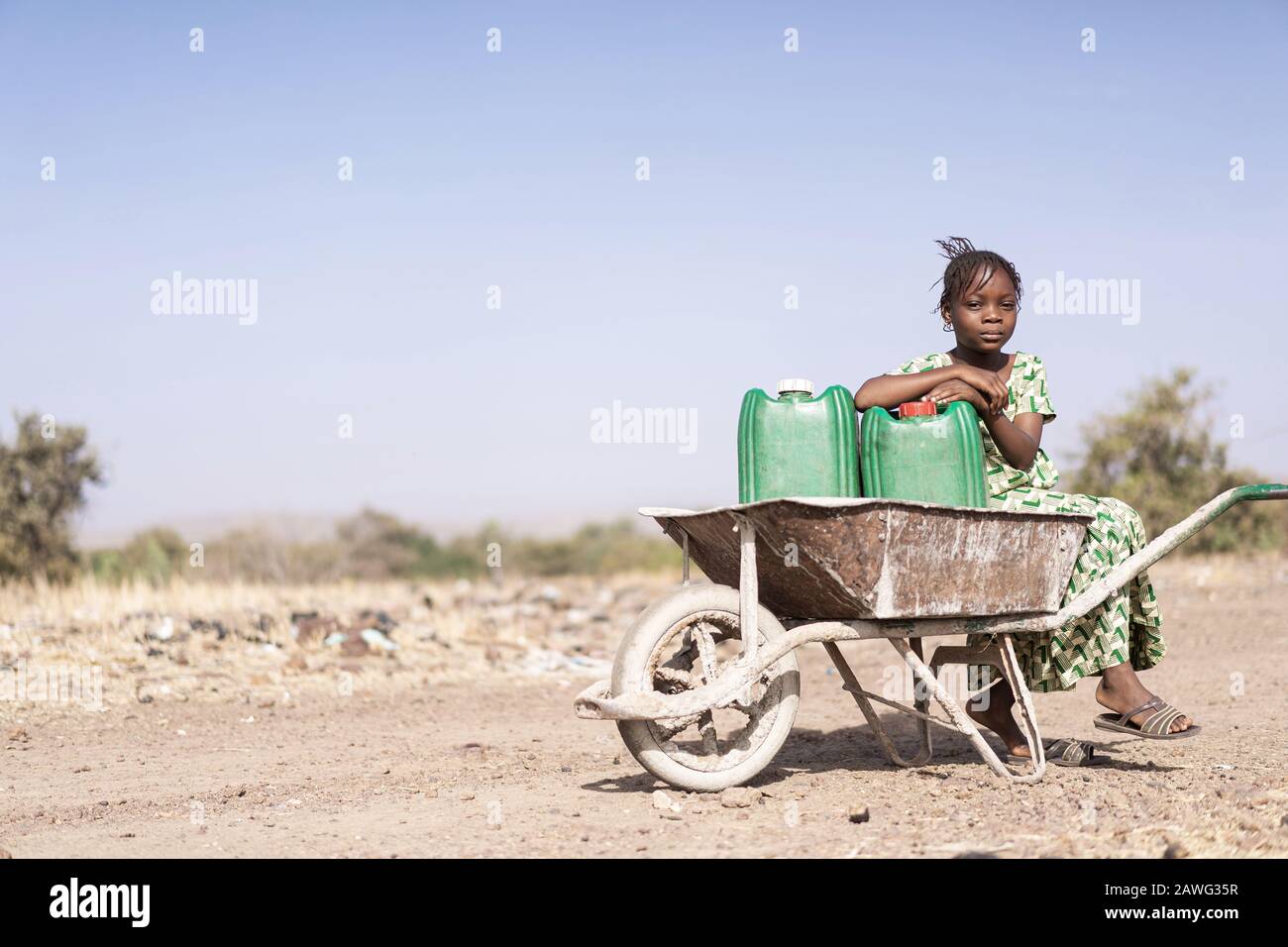 Cute Native African Women Carrying healthful Water in a village Stock Photo