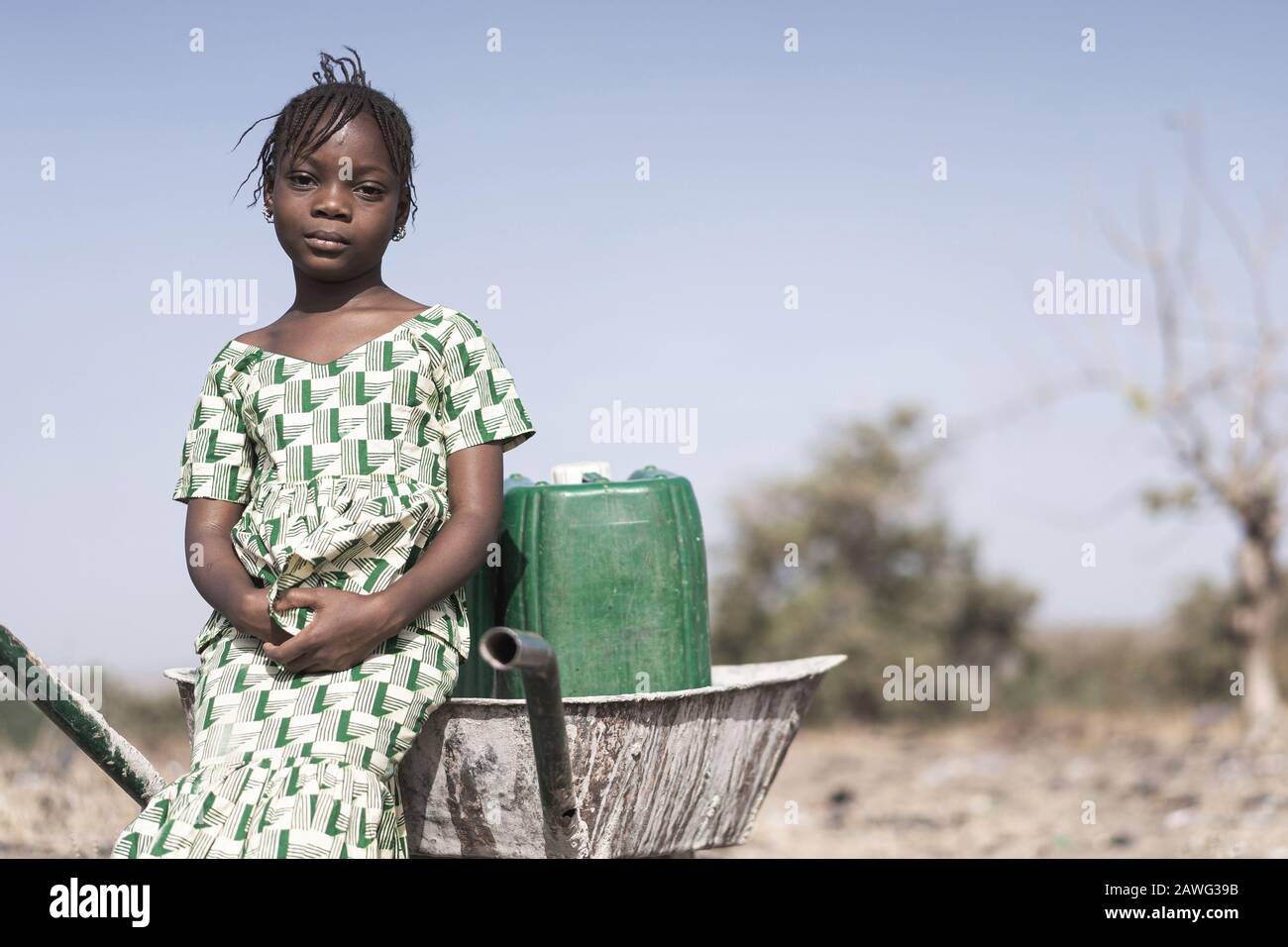 Working African ethnicity Infant getting pure Water in a natural environment Stock Photo