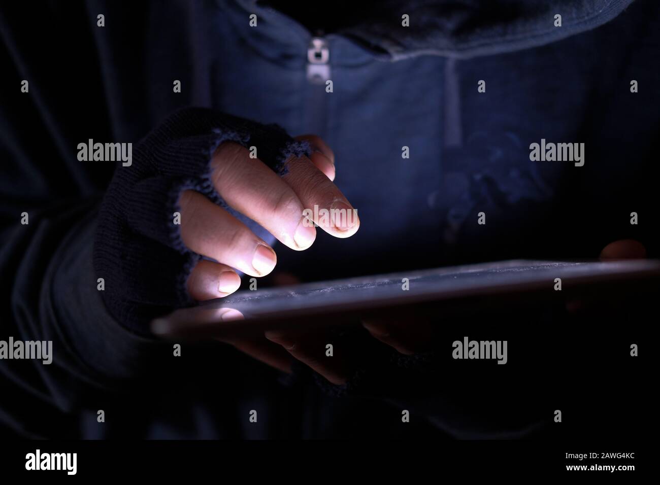 hacker hand typing on digital tablet, close up Stock Photo