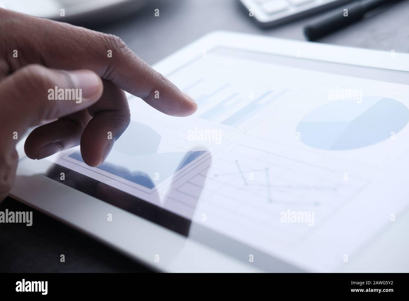 Businessman hand analyzing chart on digital tablet, closeup Stock Photo