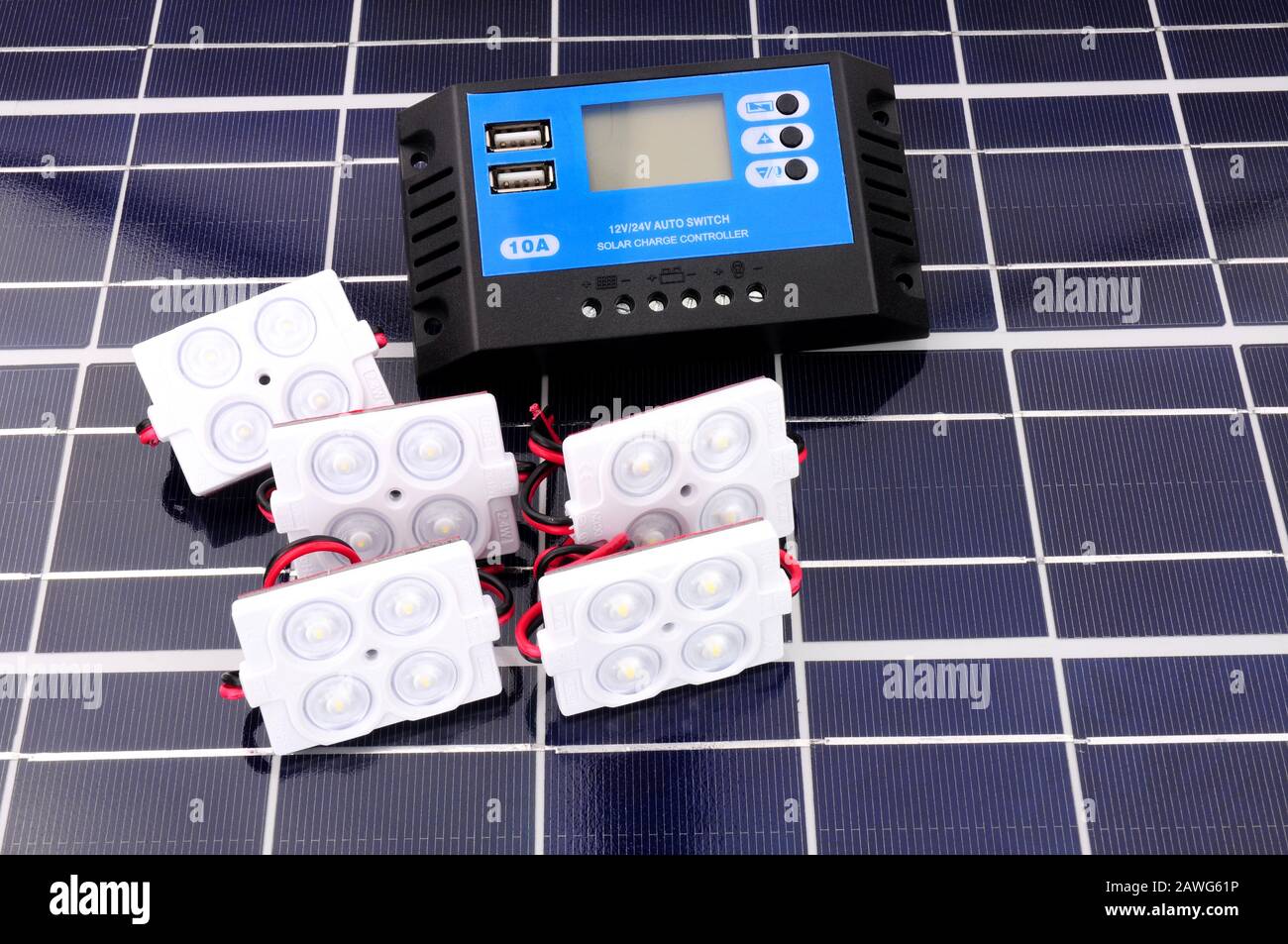 Solar lighting kit with lights and charger control unit on a solar panel background Stock Photo