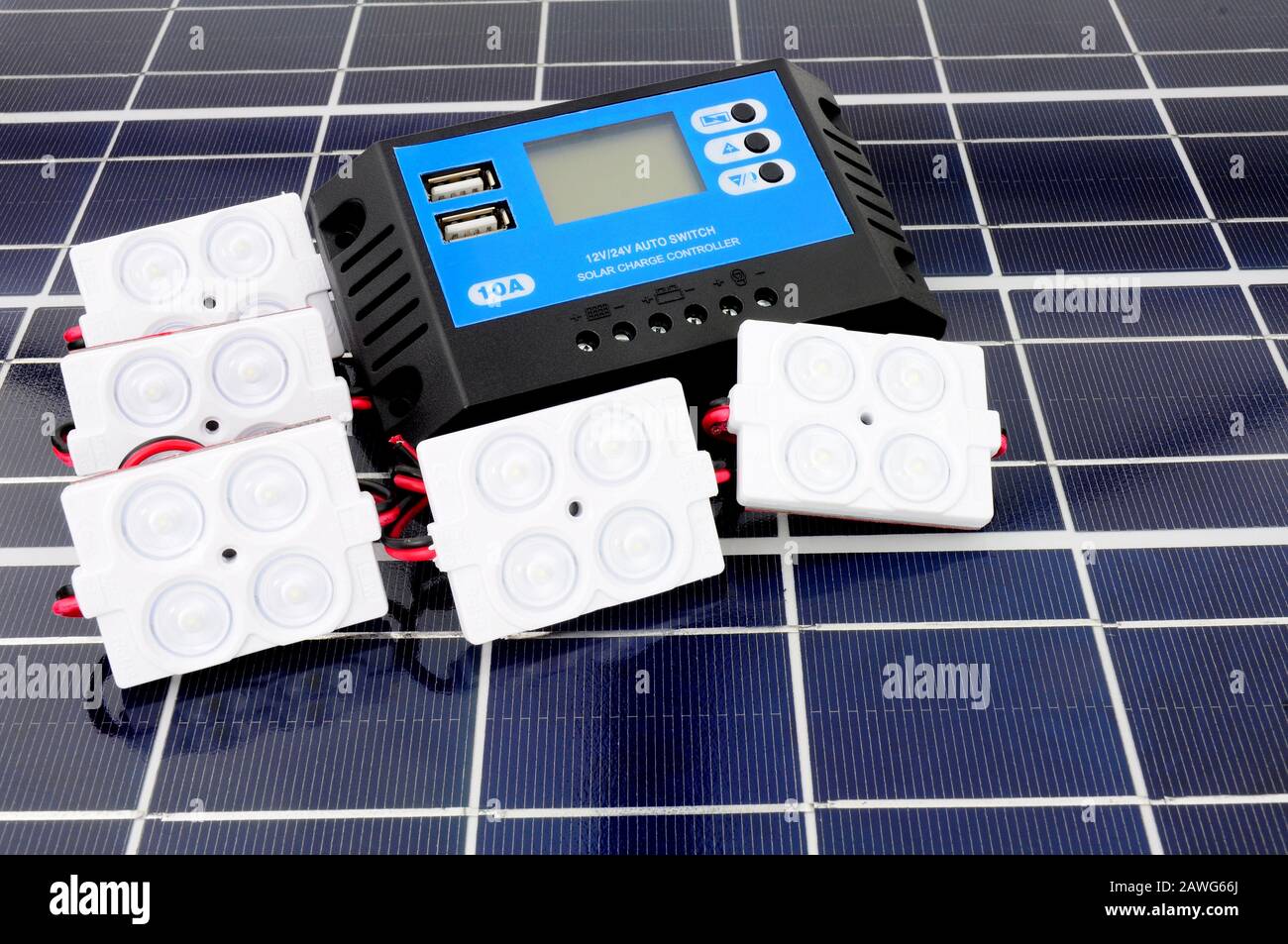 Solar lighting kit with lights and charger control unit on a solar panel background Stock Photo