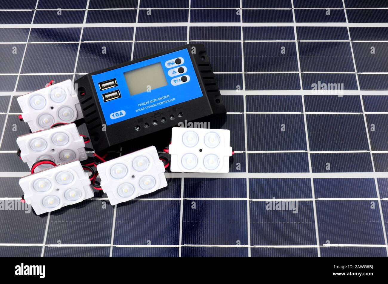 Solar lighting kit with lights and charger control unit on a solar panel background Stock Photo