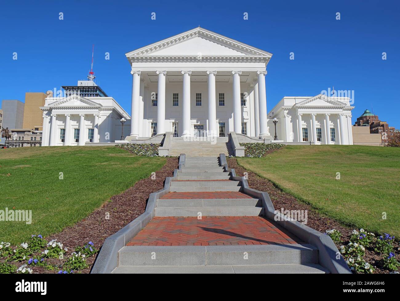 Front facade and walkway to the neoclassical style Virginia State Capitol building in Richmond against a bright blue sky Stock Photo