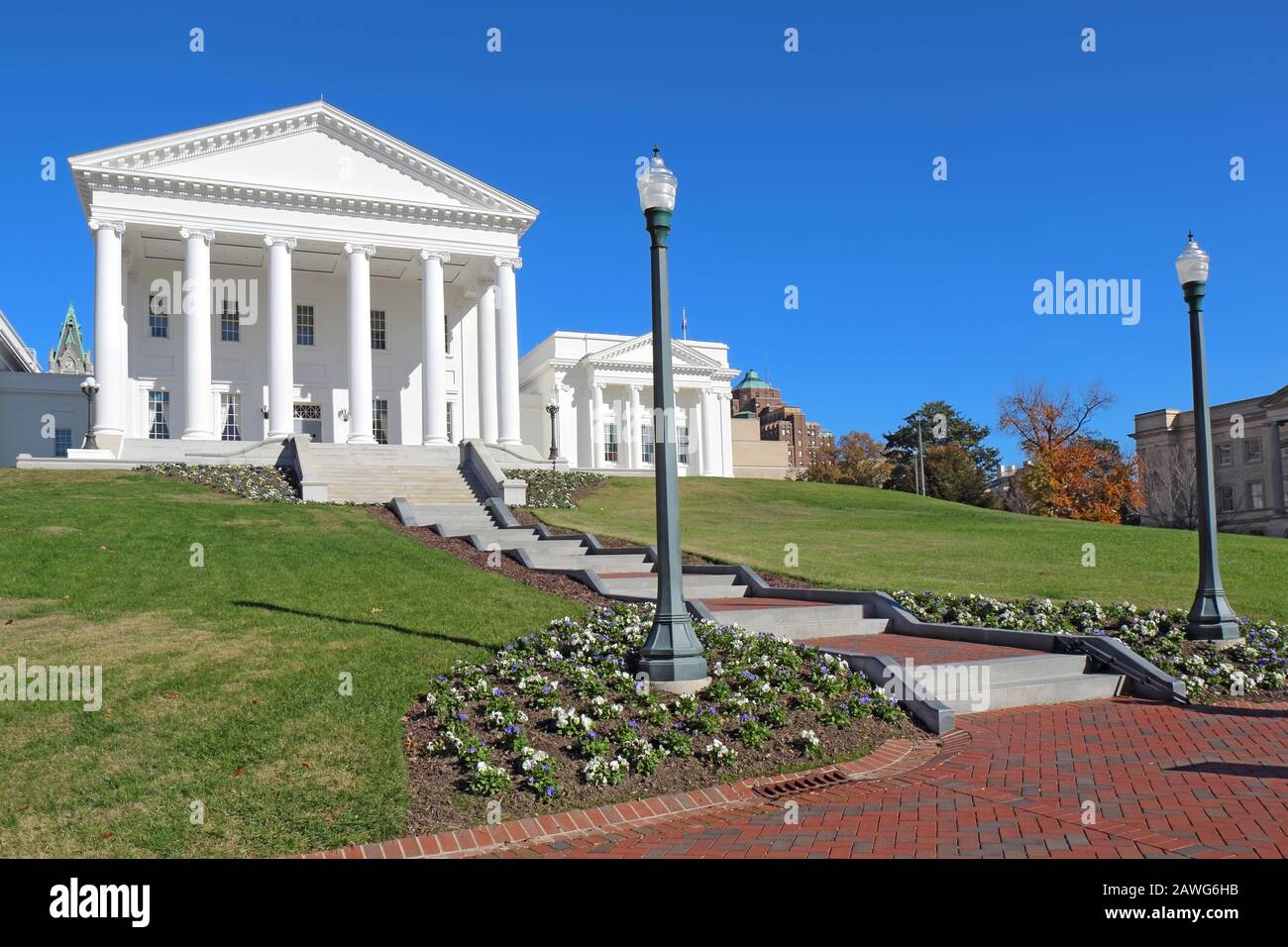 Front facade and walkway to the neoclassical style Virginia State Capitol building in Richmond against a bright blue sky Stock Photo