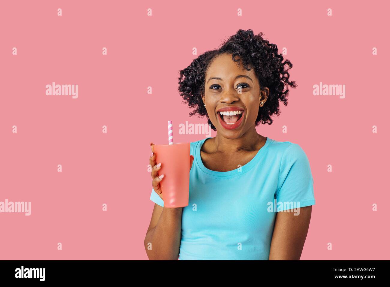 https://c8.alamy.com/comp/2AWG6W7/close-up-portrait-of-an-excited-young-smiling-woman-holding-a-drinking-cup-with-straw-and-looking-at-camera-with-mouth-open-2AWG6W7.jpg