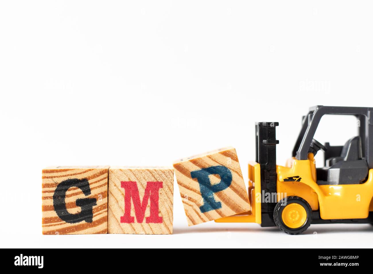 Toy forklift hold wood letter block P to complete word GMP (Abbreviation of Good Manufacturing Practice) on white background Stock Photo