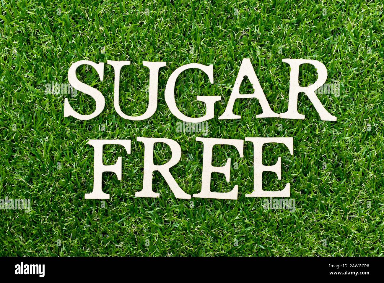 Wood alphabet letter in word sugar free on green grass background Stock Photo