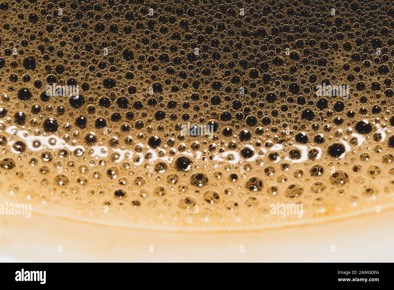 Coffee foam with bubbles macro texture. froth drink background Stock Photo