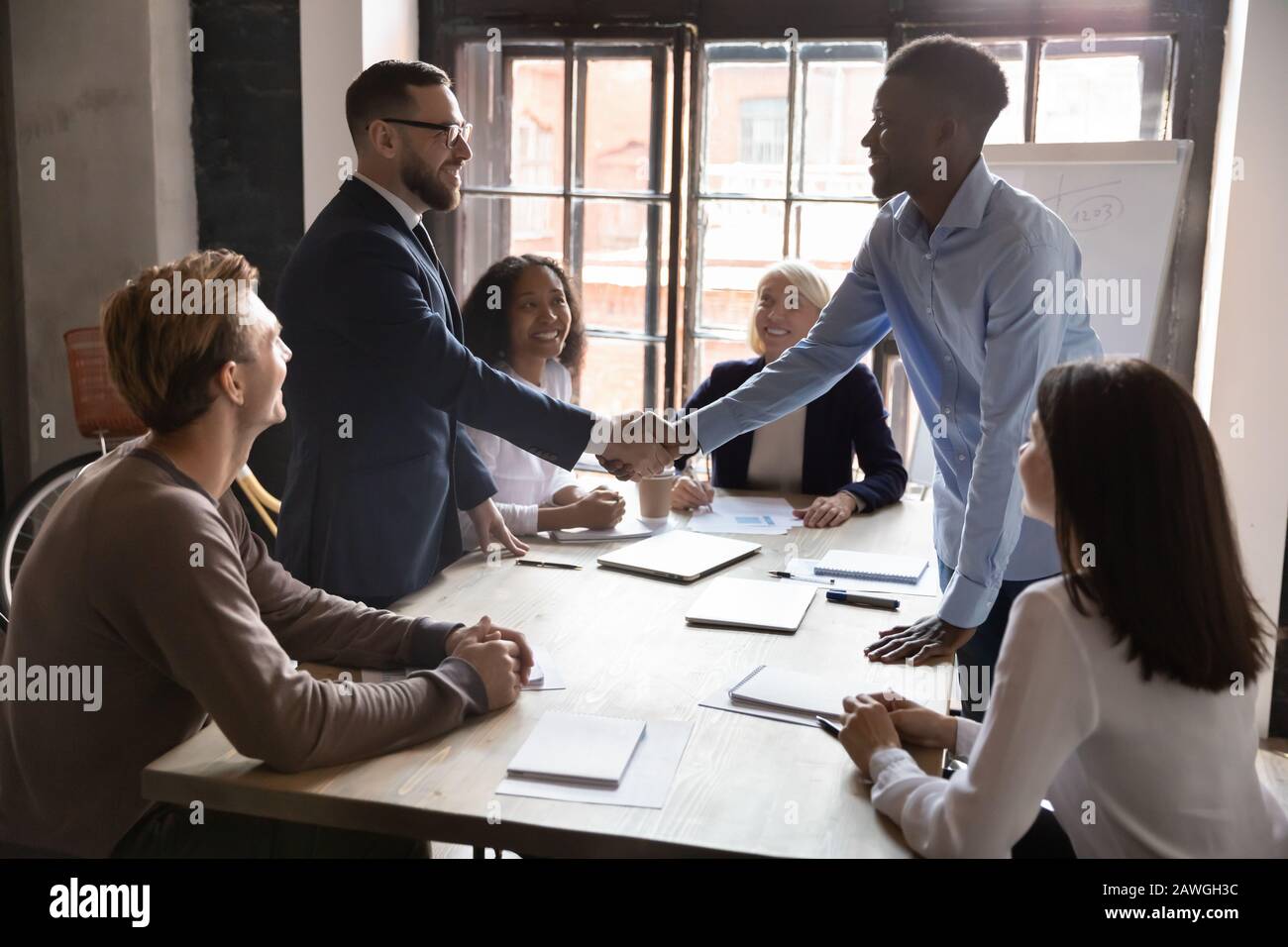 African caucasian ethnicity businessmen party leaders shaking hands starting negotiations Stock Photo