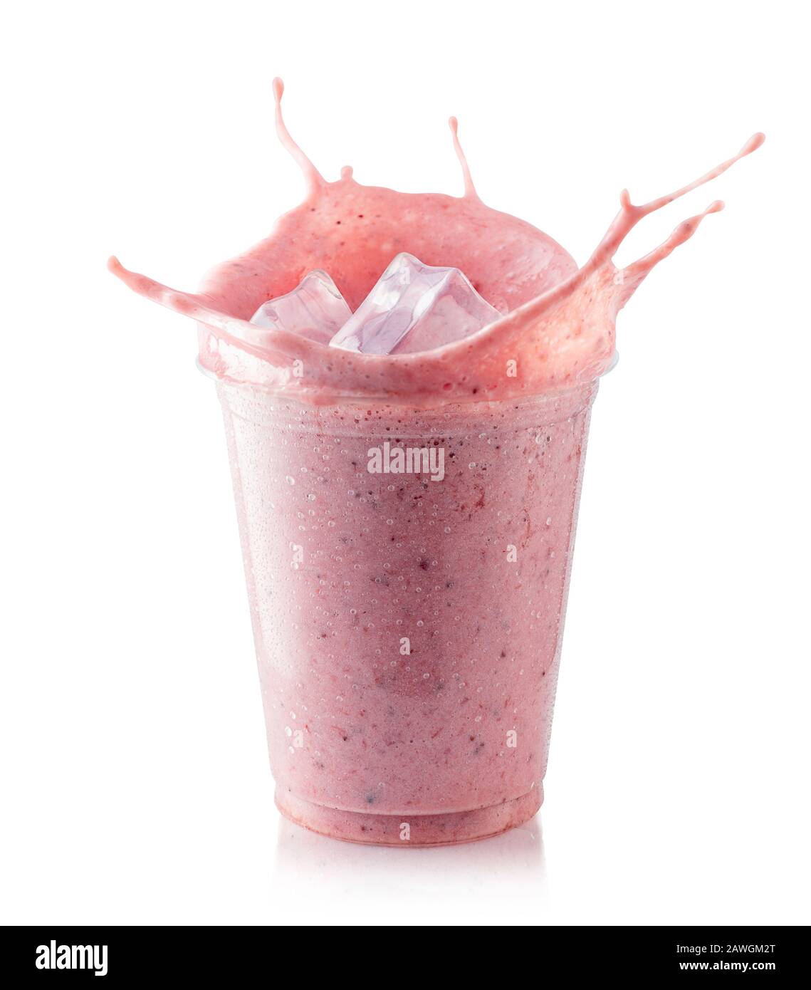 cold strawberry milkshake or smoothie with ice in disposable plastic glass isolated on white background Stock Photo