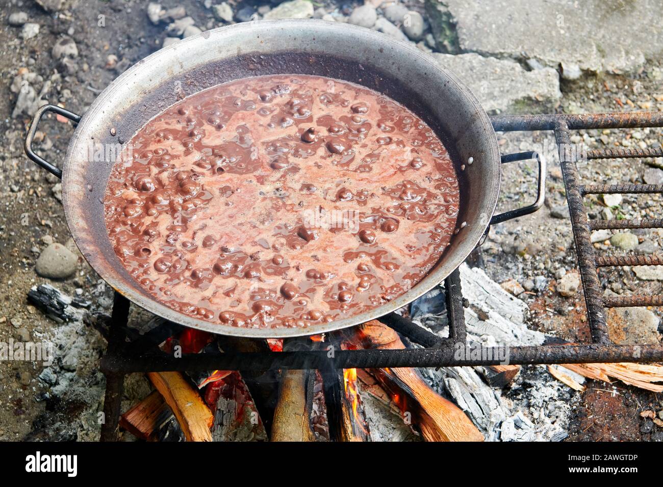 Close-up of a pork blood stew boiling in a a wok frying pan on a ...