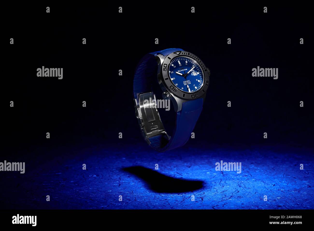 Blue Glycine Watch Floating Above Shadow on Blue Background Stock Photo