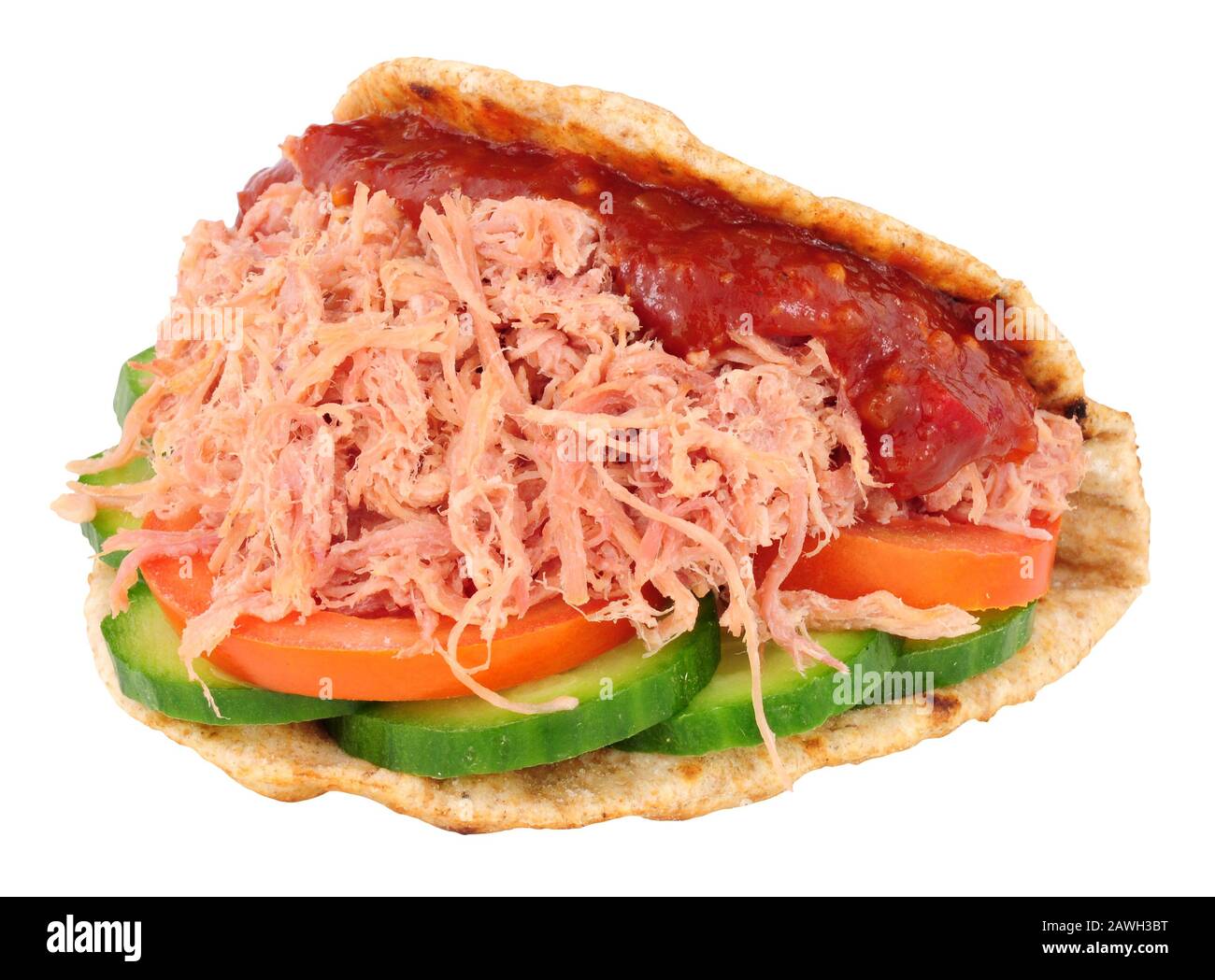 Shredded ham salad sandwich in a folded wholemeal flatbread isolated on