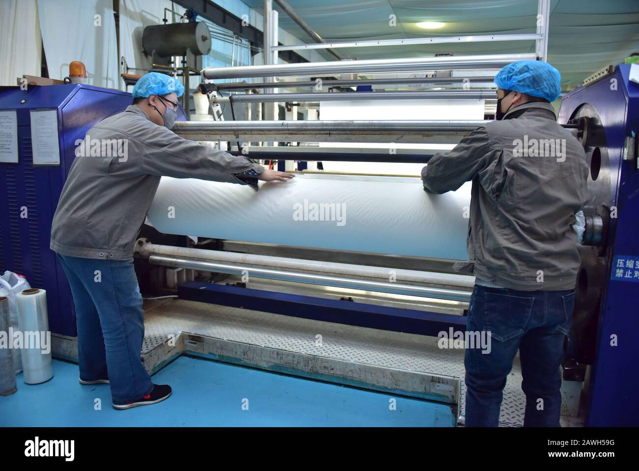 Hebei, Hebei, China. 7th Feb, 2020. Hebei, CHINA-Workers speed up the production of PE breathable membranes for medical use in the embossing workshop of Xinle plastic film co., LTD., Shijiazhuang, Hebei province, Feb. 7, 2020.To help combat the pneumonia epidemic caused by the new coronavirus, the company's embossing workshop, which produces PE breathable membranes for medical use, operates around the clock to ensure supplies of raw materials to downstream isolation garment manufacturers. Credit: SIPA Asia/ZUMA Wire/Alamy Live News Stock Photo