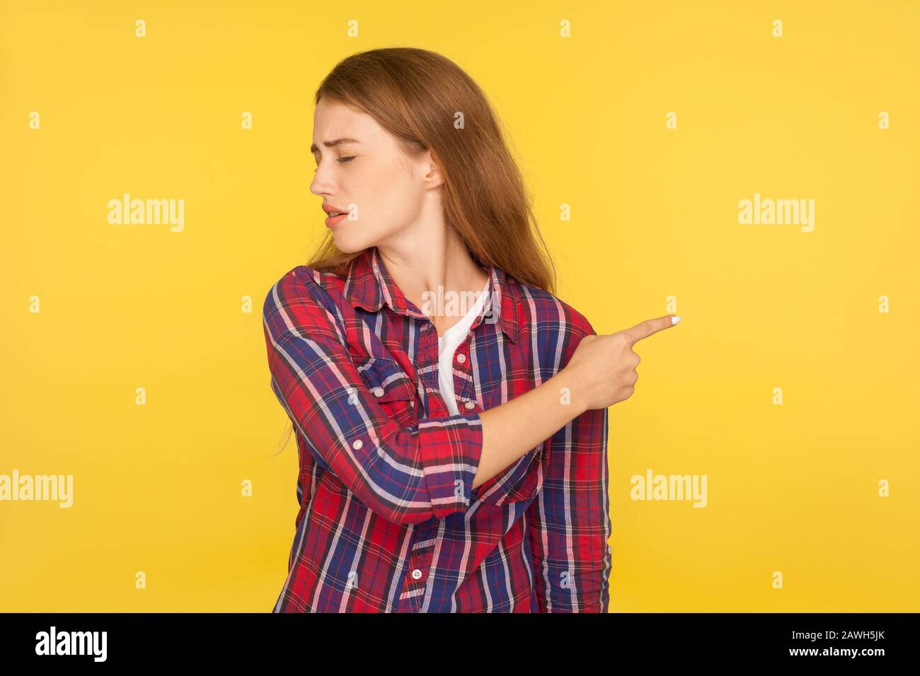 Conflict and breakup. Portrait of irritated ginger girl in checkered shirt turning away and showing gesture get out, asking to leave, feeling betrayed Stock Photo