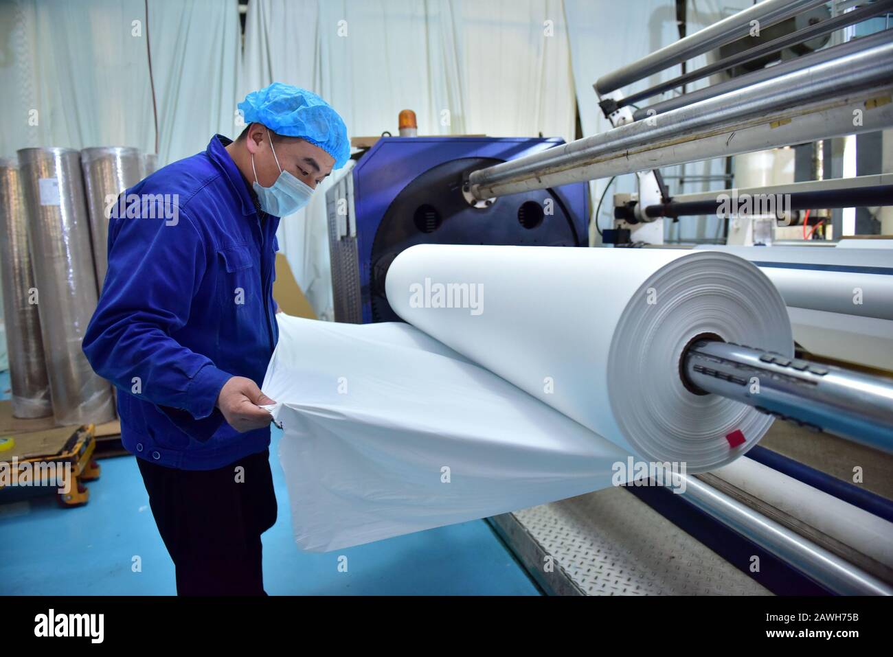 Hebei, Hebei, China. 7th Feb, 2020. Hebei, CHINA-Workers speed up the production of PE breathable membranes for medical use in the embossing workshop of Xinle plastic film co., LTD., Shijiazhuang, Hebei province, Feb. 7, 2020.To help combat the pneumonia epidemic caused by the new coronavirus, the company's embossing workshop, which produces PE breathable membranes for medical use, operates around the clock to ensure supplies of raw materials to downstream isolation garment manufacturers. Credit: SIPA Asia/ZUMA Wire/Alamy Live News Stock Photo