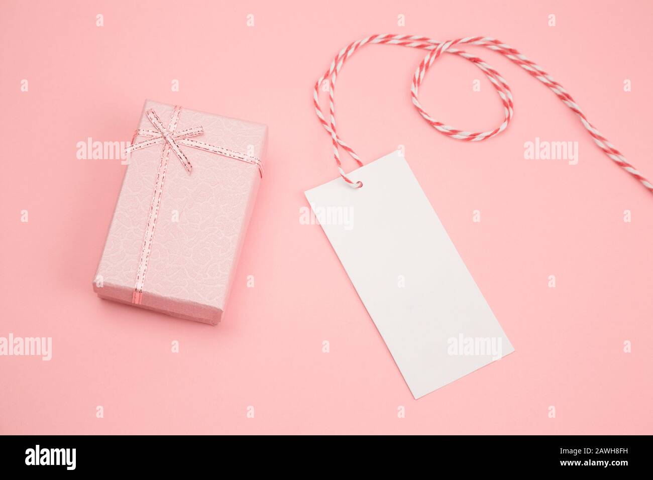 top view flat lay pink gift box and white blank label with place for ...