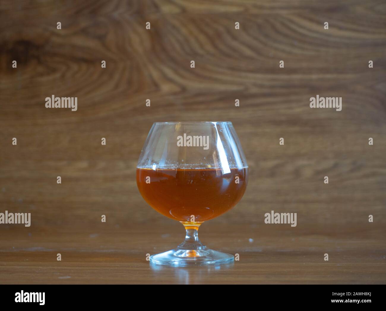 composition with glass with delicious whiskey on oak boards Stock Photo