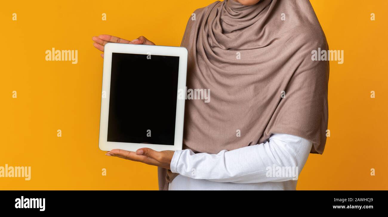 Download Unrecognizable Woman In Headscarf Holding Digital Tablet With Black Screen Mockup Stock Photo Alamy