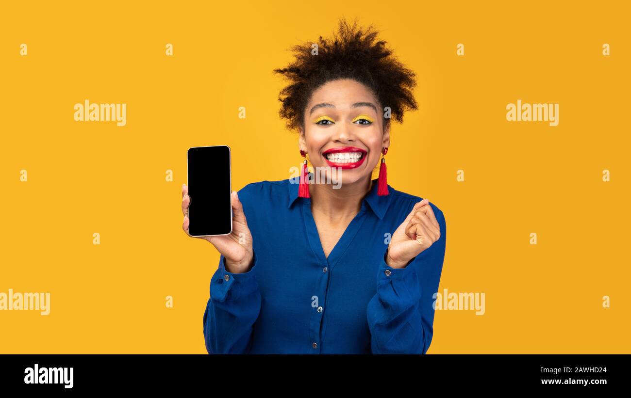 Afro girl showing blank black cellphone screen Stock Photo