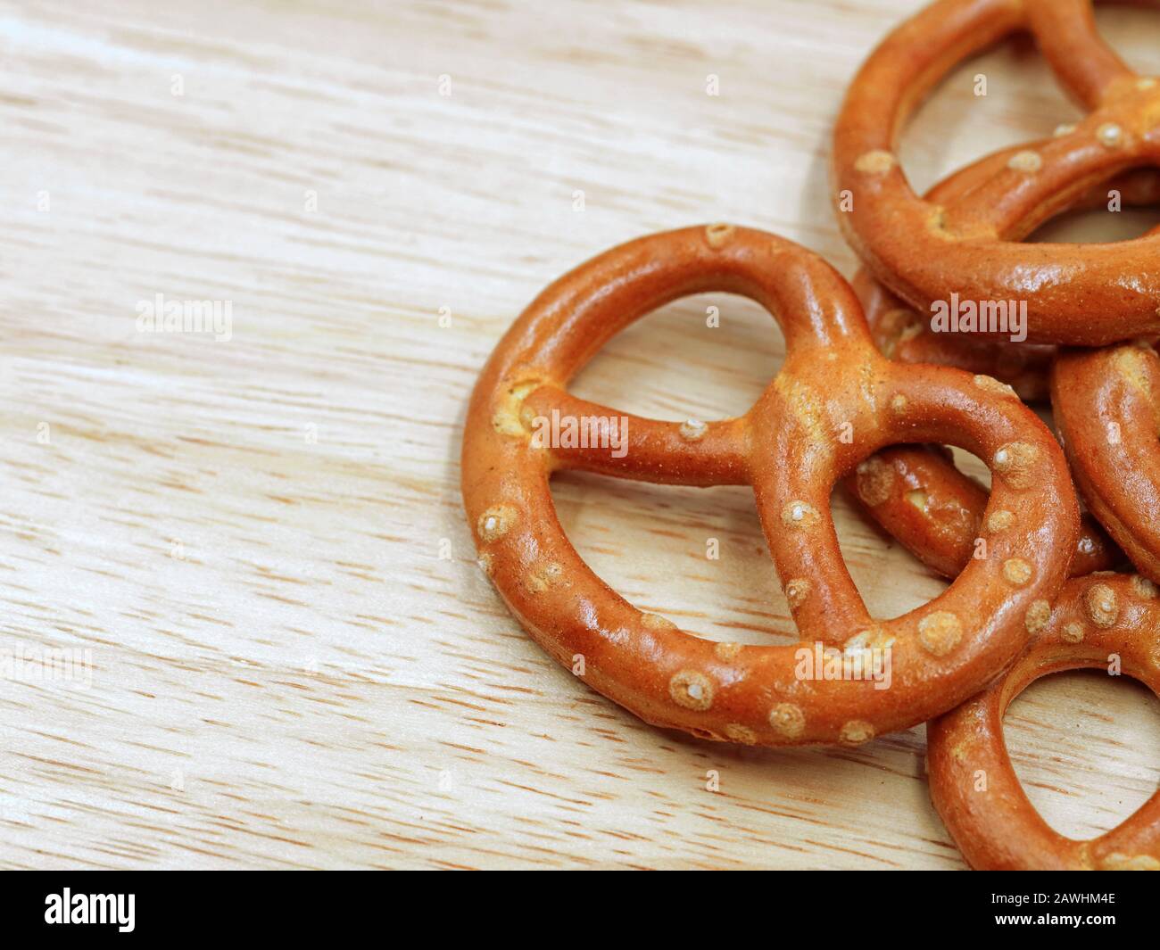 close up of salty crispy cracker mini pretzels on wooden table background with copy space Stock Photo
