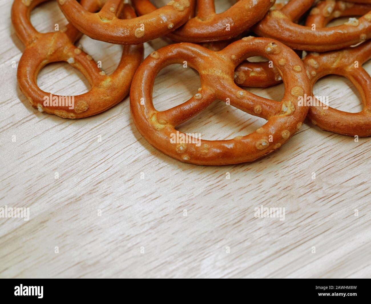 close up of salty crispy cracker mini pretzels on wooden table background with copy space Stock Photo