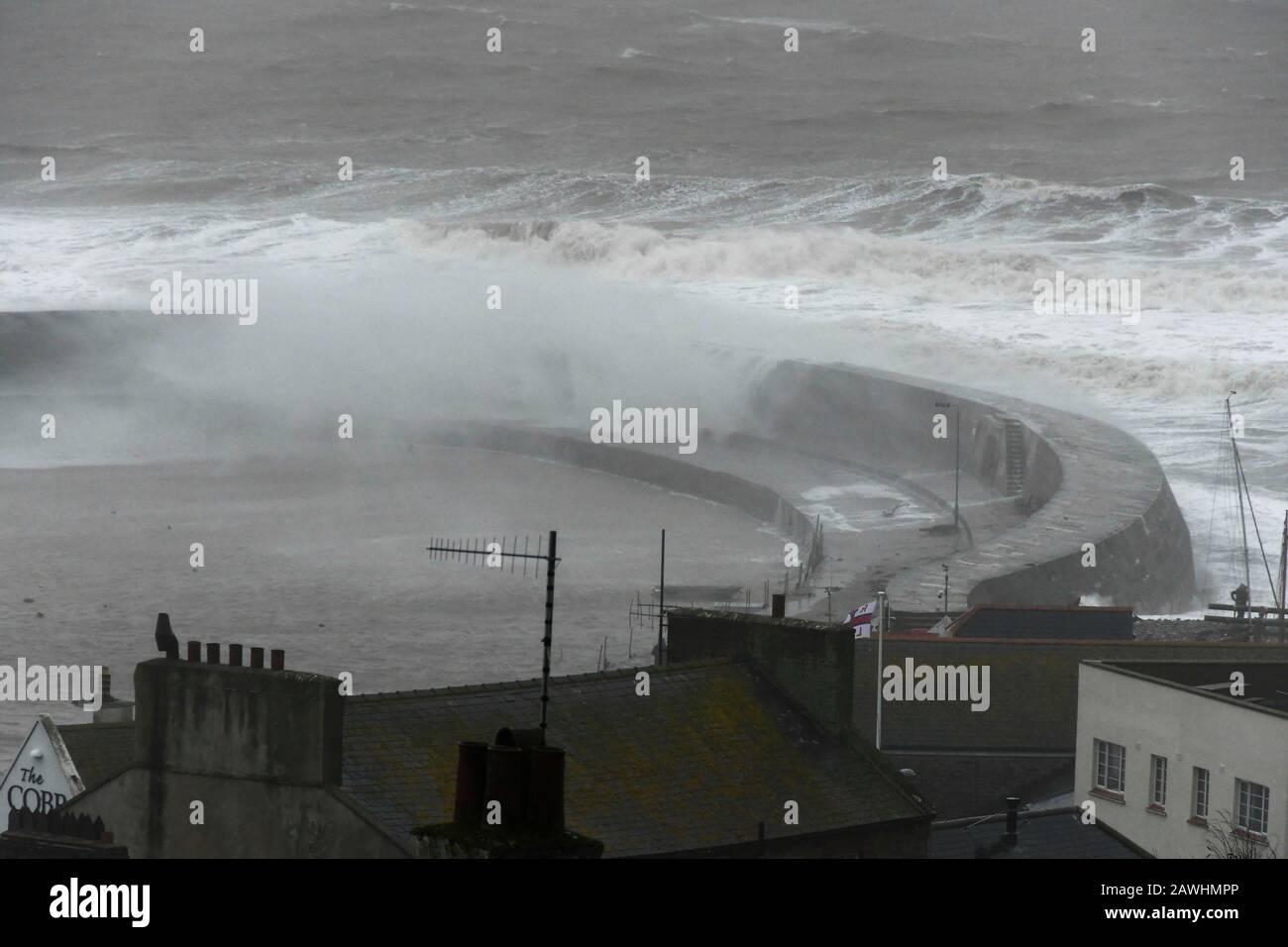 Lyme Regis, Dorset, UK.  9th February 2020. UK Weather.  Large stormy waves from Storm Ciara smash against the historic Cobb Harbour wall at Lyme Regis in Dorset.  Picture Credit: Graham Hunt/Alamy Live News Stock Photo