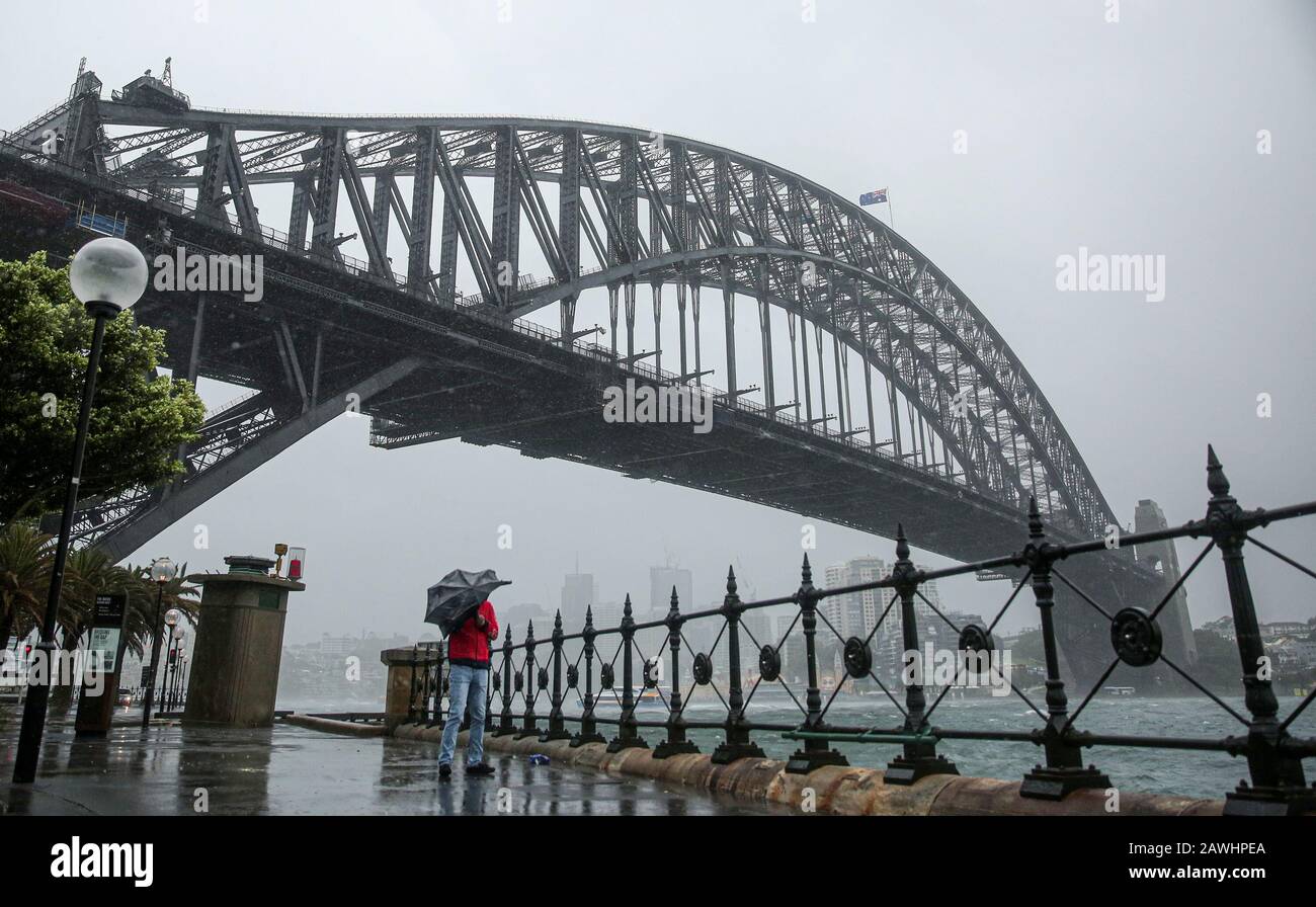 Sydney, Australia. 9th Feb, 2020. A citizen walks in the rain in Sydney, Australia, on Feb. 9, 2020. A huge rainfall hits Australia's bushfire-ravaged east coast on Friday. In the midst of the worst drought on record, the huge rainfall on Friday is predicted to stick around for at least a week and may bring relief to the long-suffering communities. Although the rain is mostly being seen as good news, authorities are also warning that fire-damaged areas are at extreme risk of flooding. Credit: Bai Xuefei/Xinhua/Alamy Live News Stock Photo