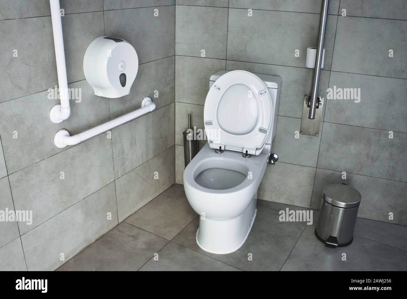 Interior of a disabled restroom with supports on the walls Stock Photo
