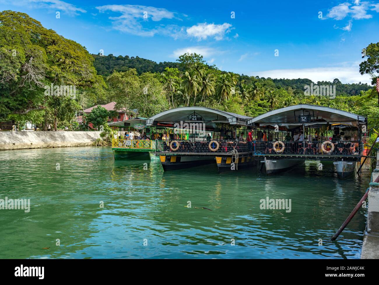 Cruise ship on the  Loboc River is a river in the Bohol province of the Philippines. It is one of the major tourist destinations of Bohol. Stock Photo