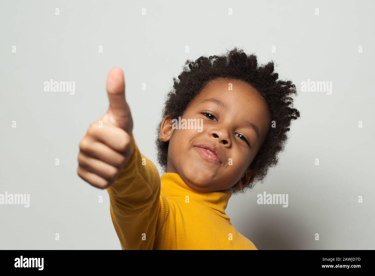 Happy African American child boy showing thumb up on white background Stock  Photo - Alamy