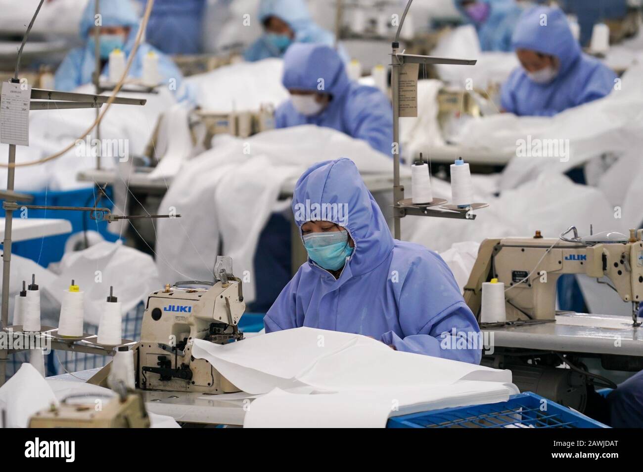 (200209) -- BEIJING, Feb. 9, 2020 (Xinhua) -- Workers make protective suits for general purposes at a production line of Hodo Group, a private-owned garment company in Wuxi, east China's Jiangsu Province, Feb. 8, 2020. (Xinhua/Li Bo) Stock Photo