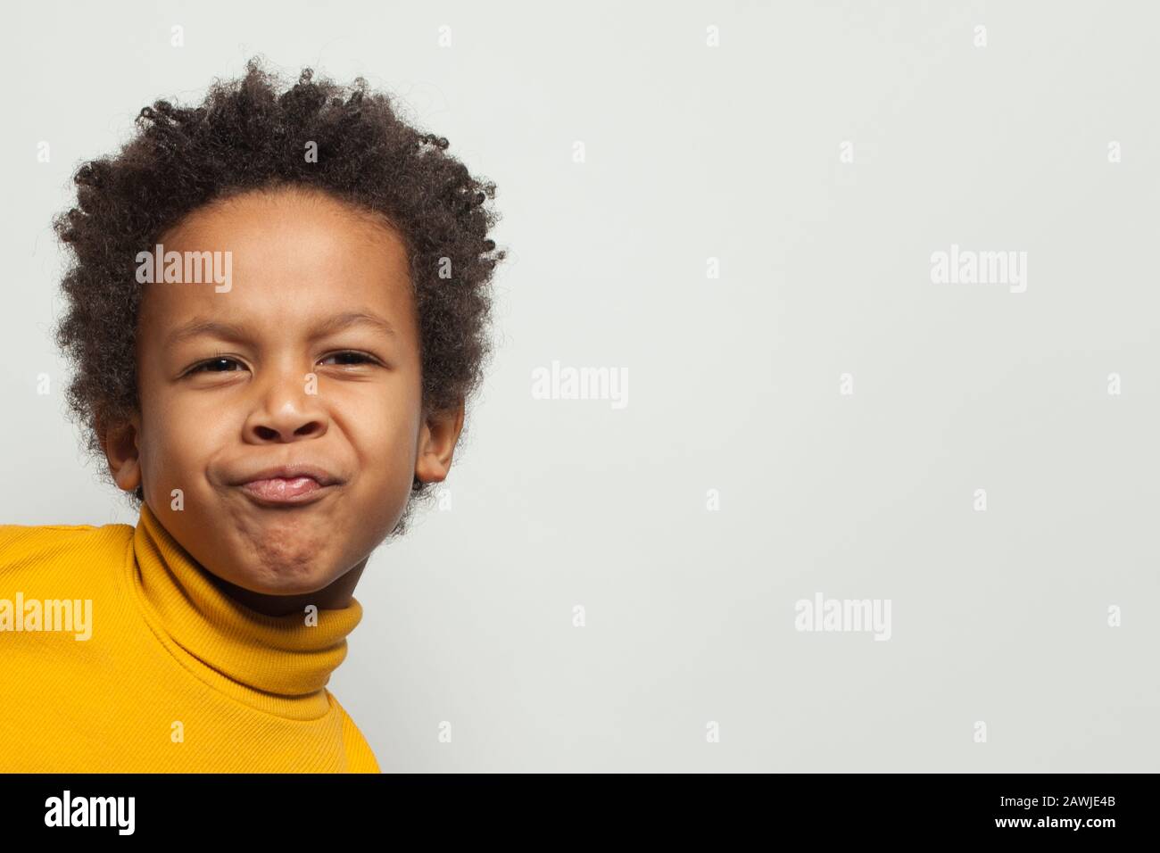 Funny black child boy grimacing on white background Stock Photo Alamy