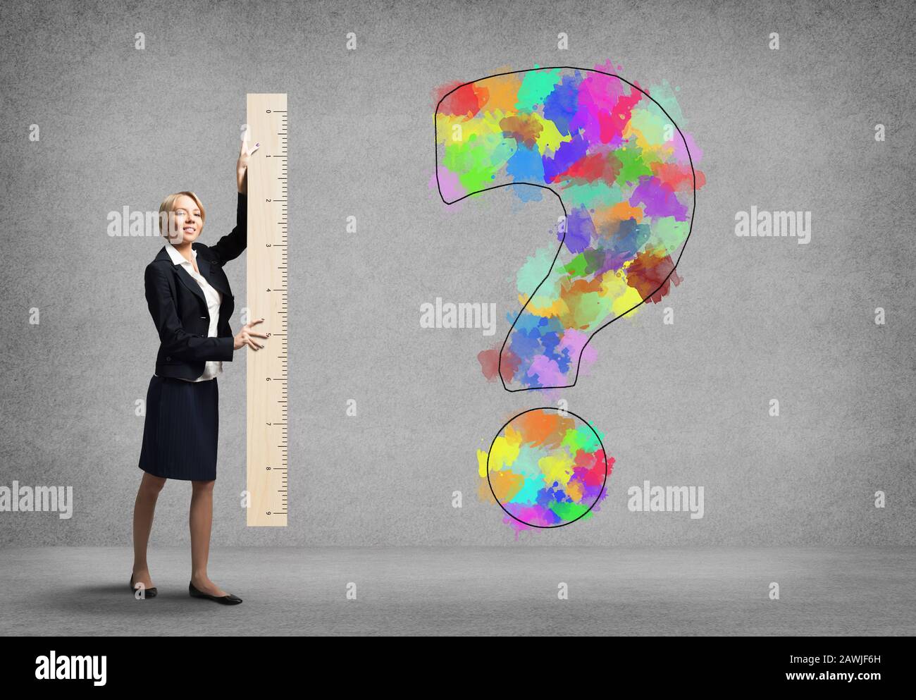 Woman in business suit holding big ruler Stock Photo - Alamy