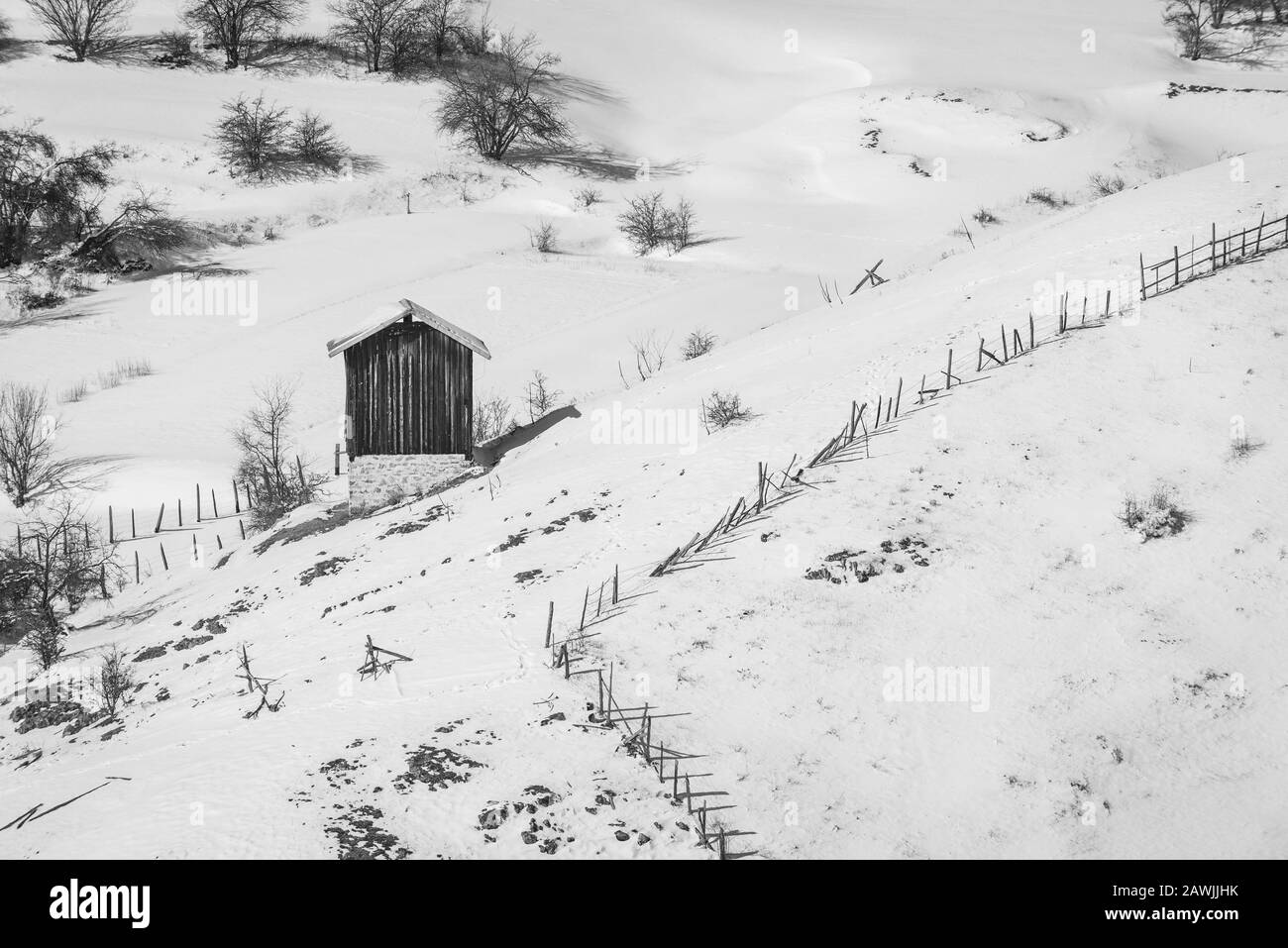 Old wooden Barn in Field, Winter mountain snow landscape Stock Photo