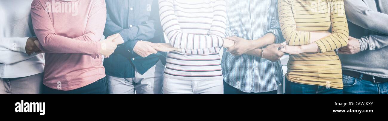 Creative team meeting hands together in line. Young business people are holding hands. Unity and teamwork concept. Stock Photo