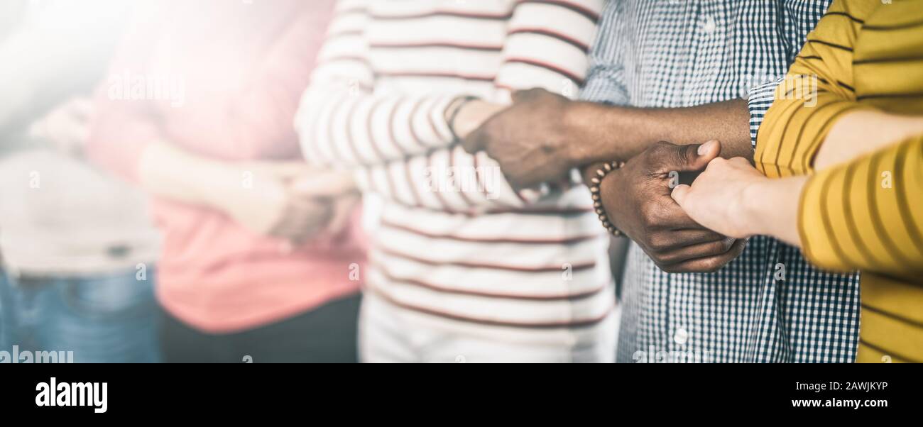 Creative team meeting hands together in line. Young business people are holding hands. Unity and teamwork concept. Stock Photo